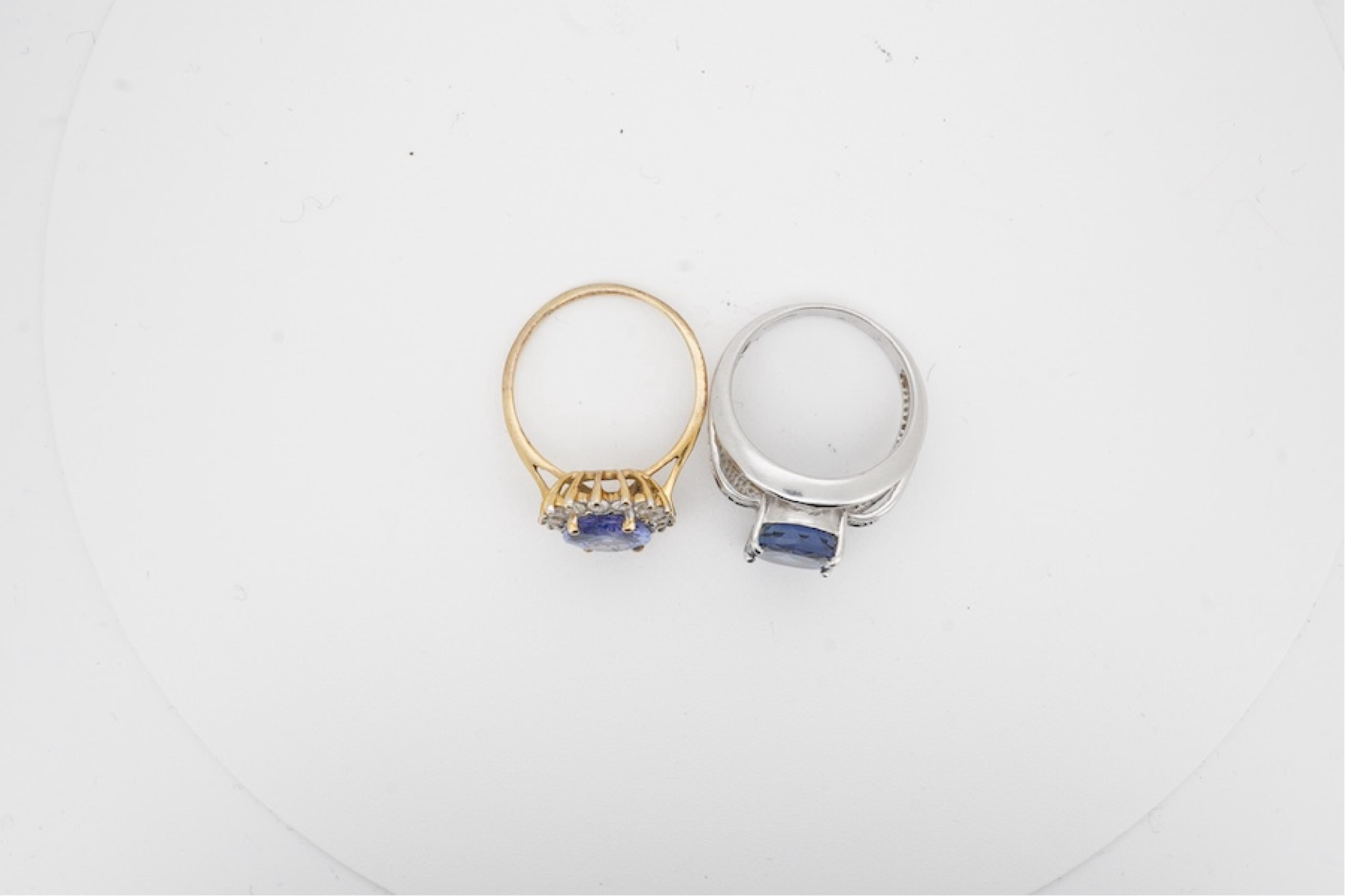 Two modern 18ct gold and gem set rings including a tanzanite and diamond set oval cluster, size Q and N, gross weight 11.5 grams. Condition - fair to good